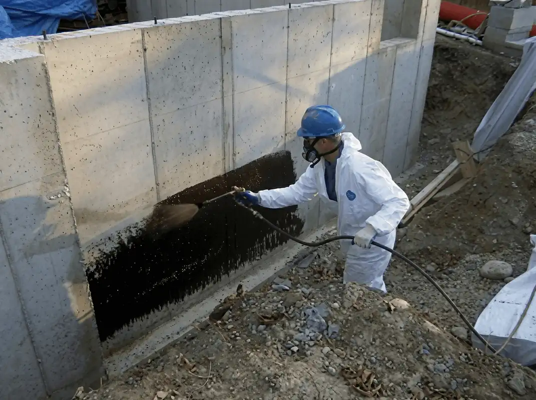 Professional waterproofing the exterior walls of the basement in Tuscaloosa, AL