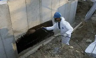 Professional waterproofing the exterior walls of the basement in Tuscaloosa, AL