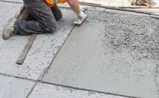Professional repairing a concrete floor in Tuscaloosa, AL