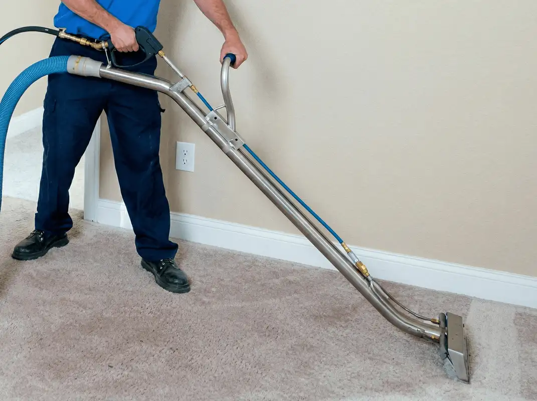 Professional operating a liquid removal machine on a carpeted floor in Tuscaloosa, AL